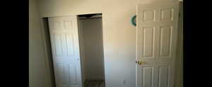Basement-bedroom with a closet and baseboards