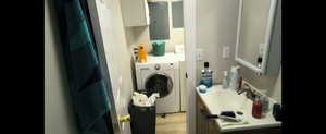 Basement-Full Bathroom with Laundry  featuring washer / clothes dryer and light wood finished floors