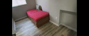 Basement-Bedroom  with wood finished floors and baseboards