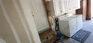 Main unit-Washroom featuring separate washer and dryer and cabinet space