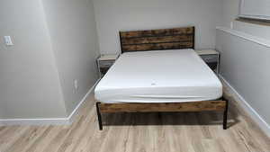 Basement-Bedroom with wood finished floors and baseboards