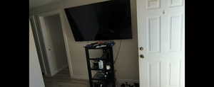 Basement-Detailed view of wood finished floors and baseboards