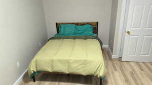 Basement-Bedroom with light wood finished floors and baseboards