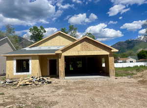 Property under construction with a mountain view and an attached garage