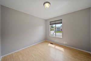 Unfurnished room featuring baseboards and wood finished floors