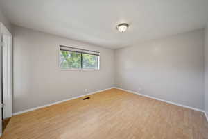 Empty room featuring light wood-style floors and baseboards