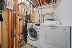 Washroom featuring washing machine and clothes dryer