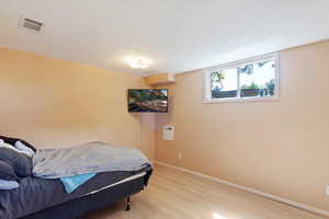 Bedroom featuring light wood LVP floors and baseboards
