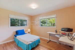 Bedroom with baseboards and wood finished floors