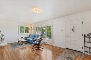 Formal living room with hardwood floors,  large windows with plantation shutters.