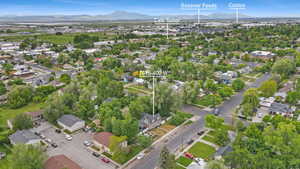 Aerial view of property and surrounding area featuring a mountain backdrop and nearby suburban area