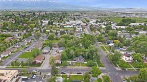 Aerial view of property and surrounding area with mountains and nearby suburban area