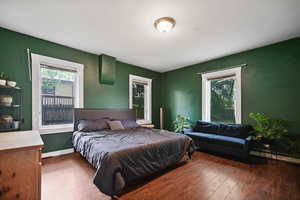 Bedroom featuring hardwood / wood-style flooring and baseboards