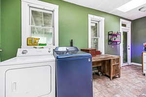 Laundry area with a skylight and washer and clothes dryer