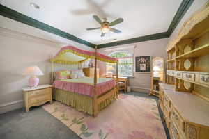 Bedroom with light colored carpet, crown molding, and ceiling fan