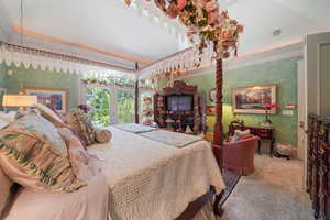 Carpeted bedroom featuring wallpapered walls and crown molding