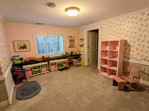 Game room featuring wallpapered walls, ornamental molding, and carpet floors