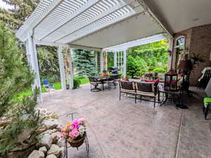 View of patio featuring outdoor dining space and a pergola