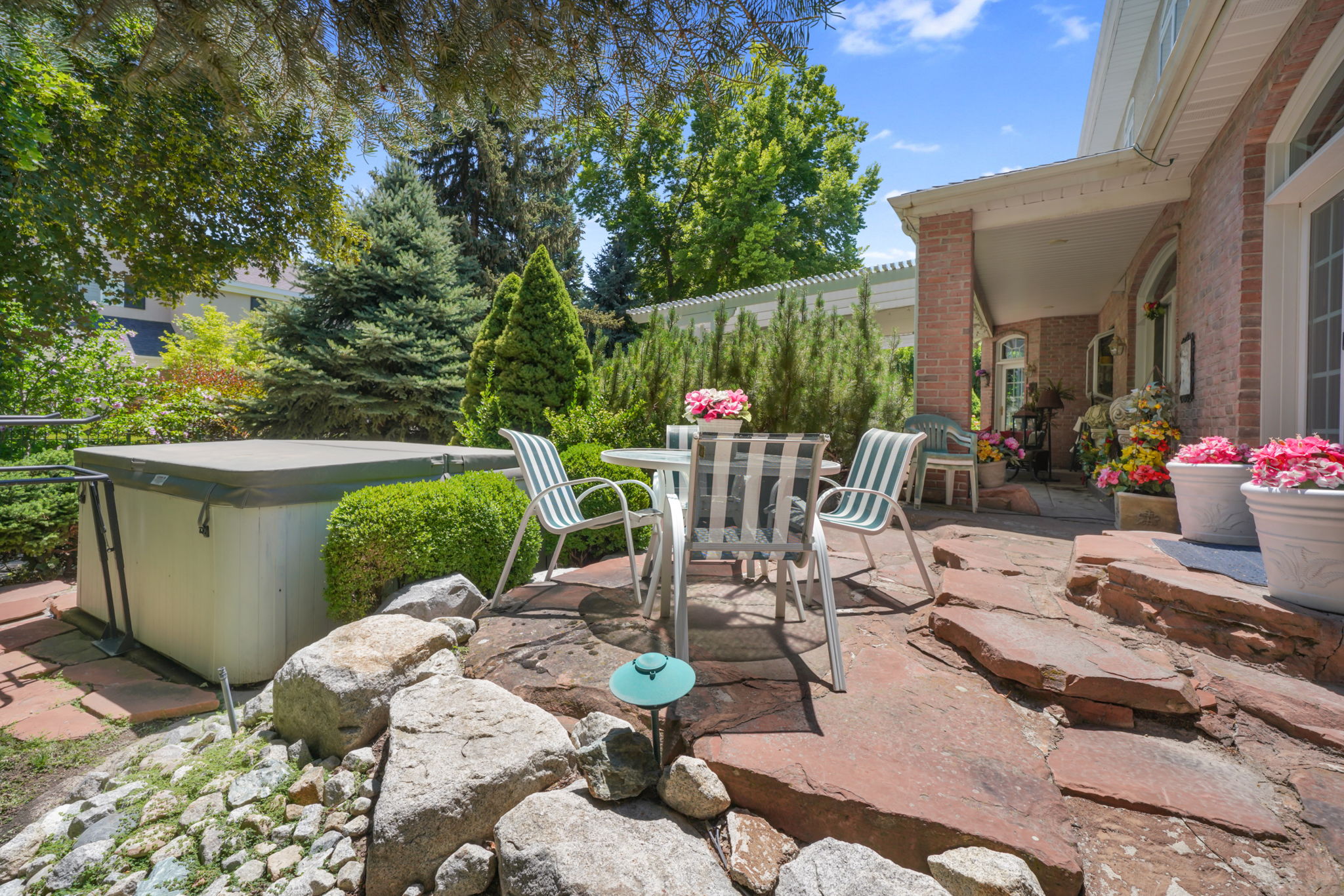 View of patio featuring outdoor dining space and a hot tub