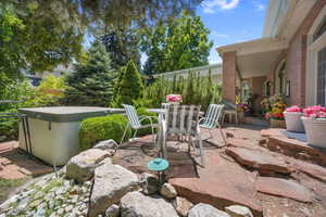 View of patio featuring outdoor dining space and a hot tub