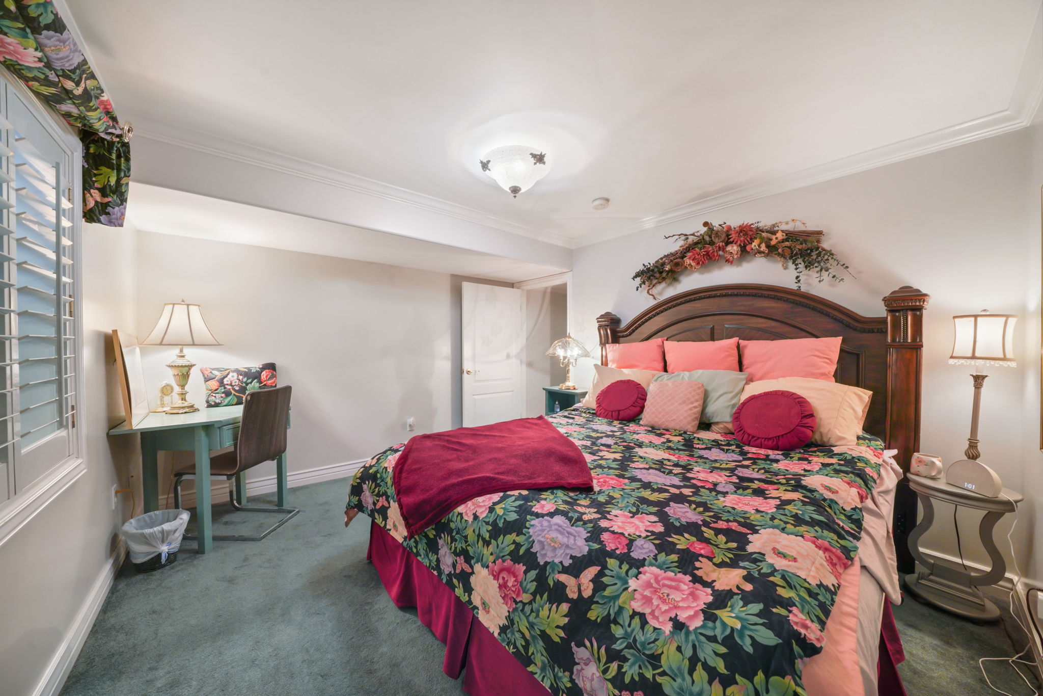 Bedroom featuring carpet flooring, crown molding, and multiple windows