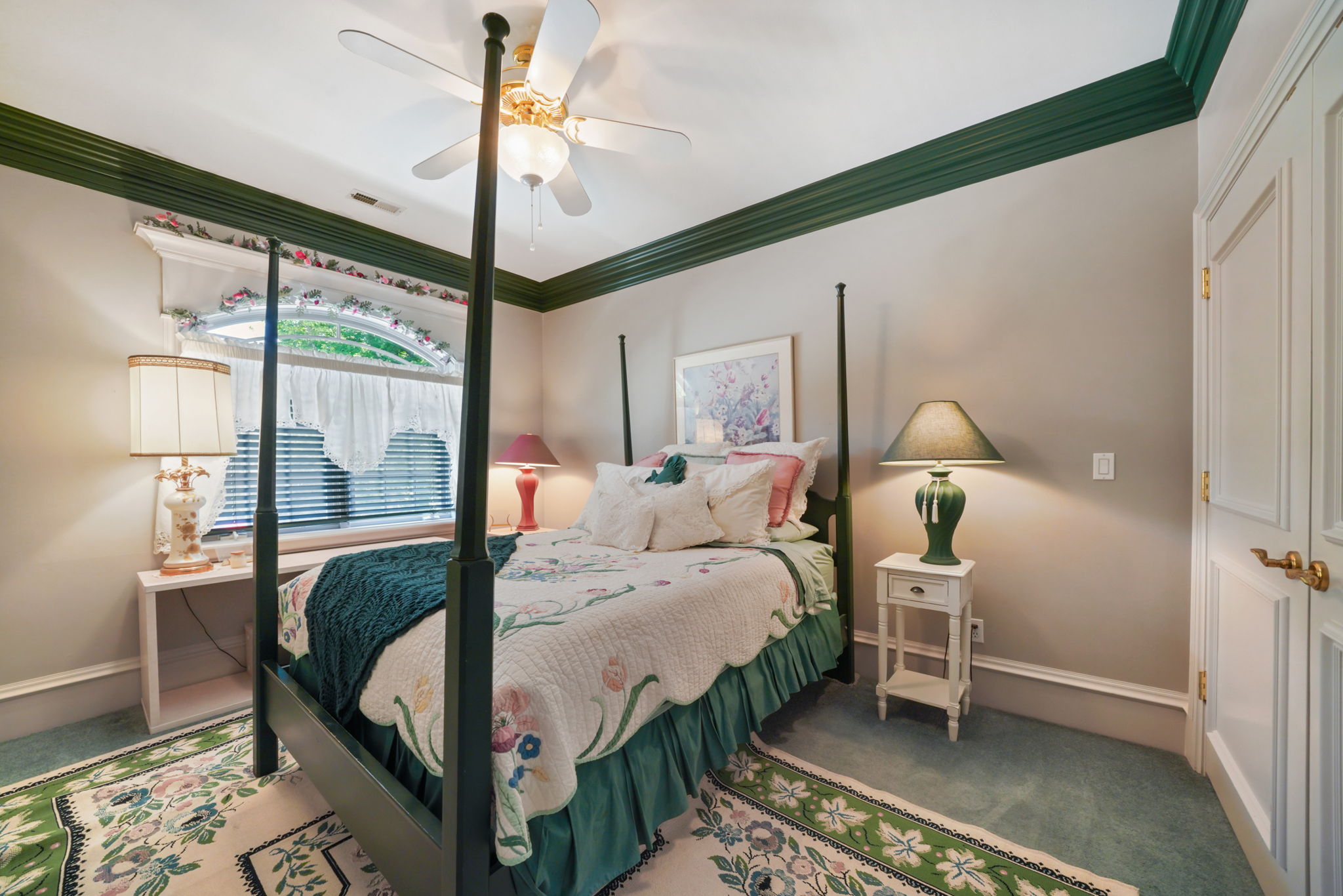 Bedroom with carpet floors, crown molding, and a ceiling fan