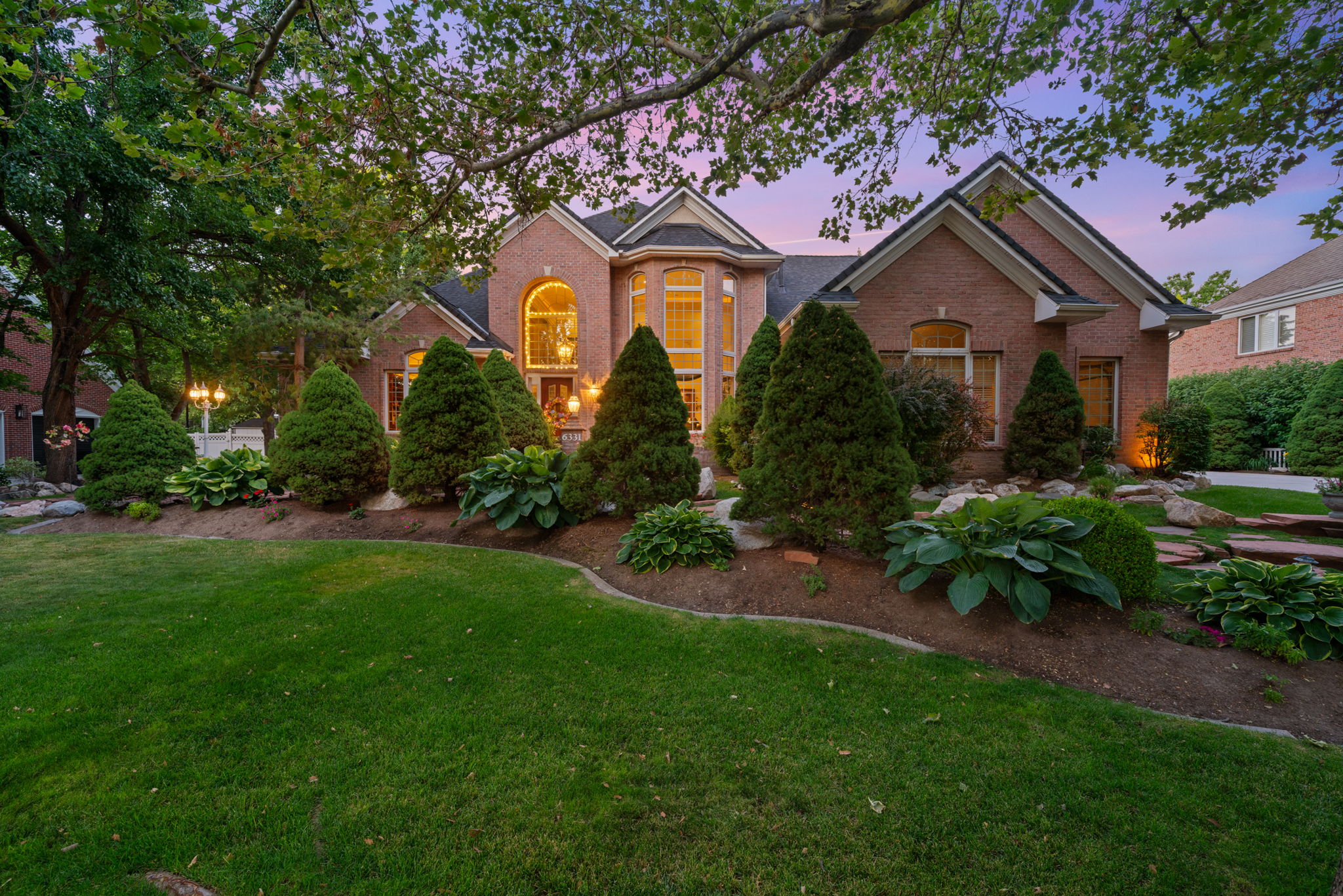 Traditional-style house featuring brick siding and a yard