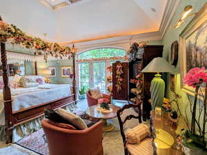 Bedroom with crown molding, access to exterior, a towering ceiling, and wallpapered walls
