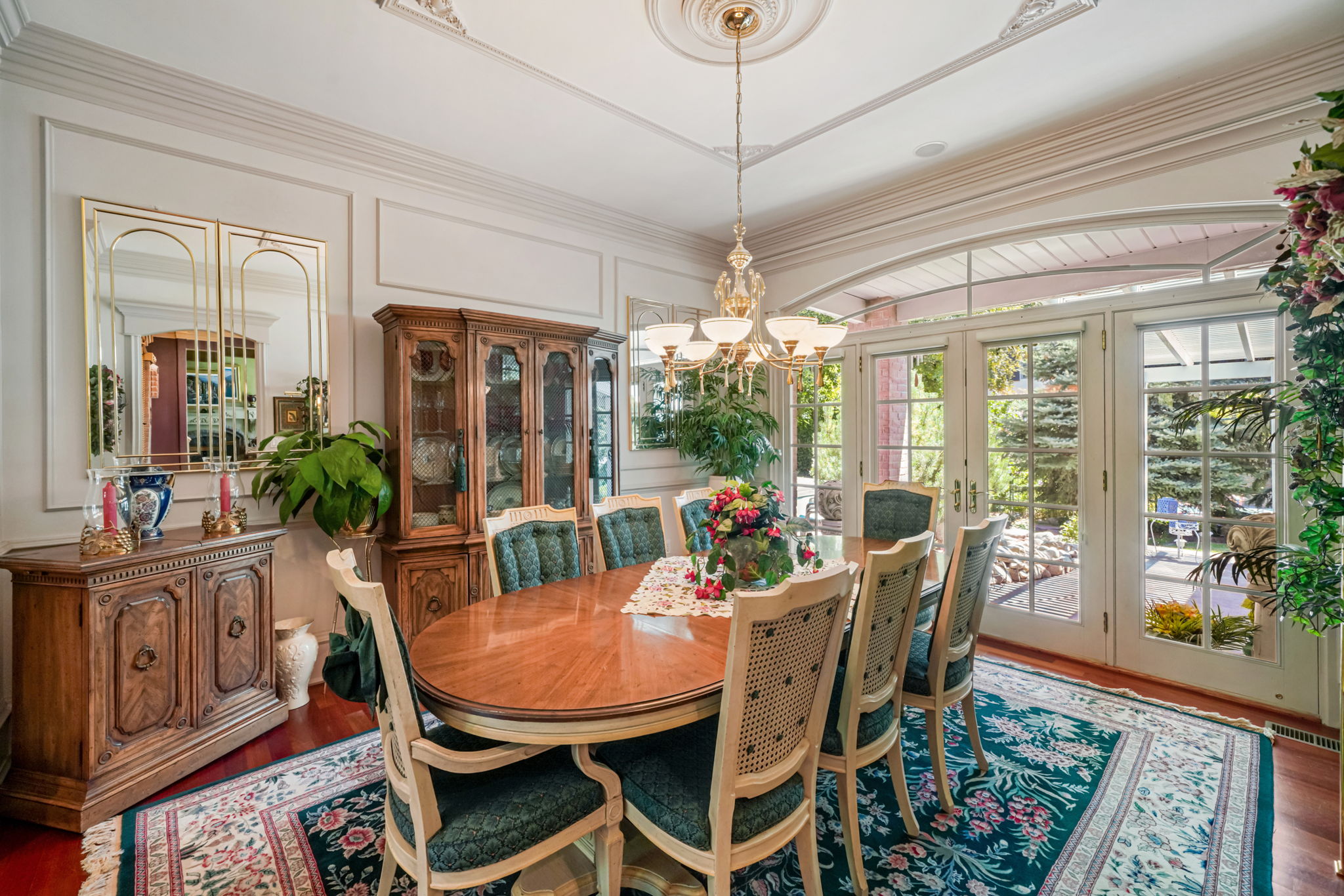 Dining room with french doors, a chandelier, wood finished floors, and a decorative wall