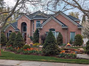 Traditional home with brick siding and a shingled roof