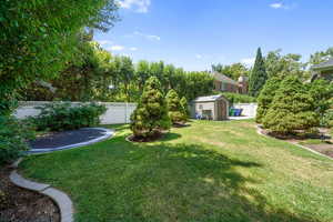 Fenced backyard with a storage shed