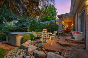 View of patio featuring a hot tub and outdoor dining space