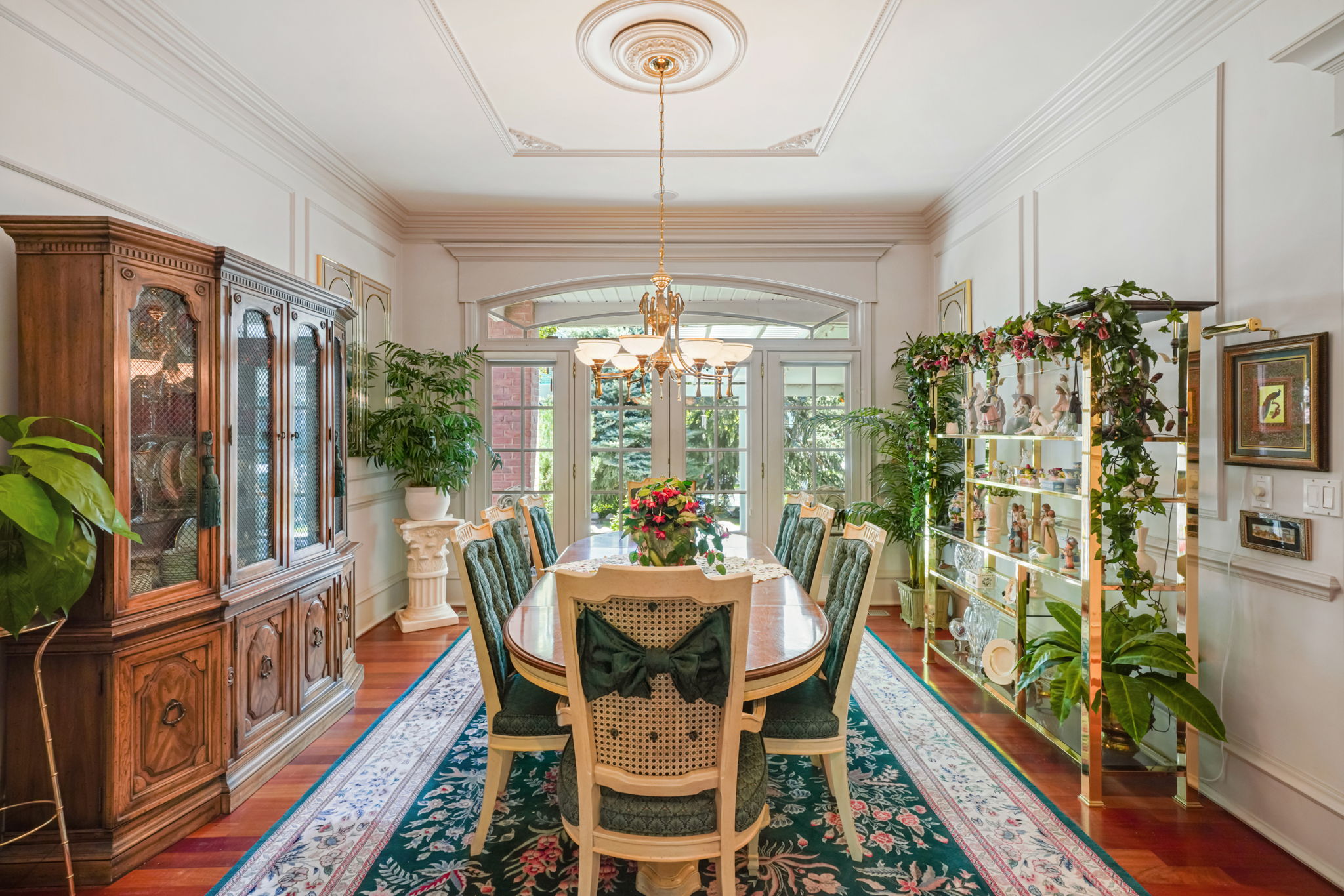 Dining room featuring a chandelier, wood finished floors, and crown molding