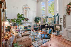 Living area featuring a towering ceiling and wood finished floors