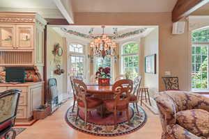 Dining space featuring a chandelier, light wood-type flooring, and ornamental molding