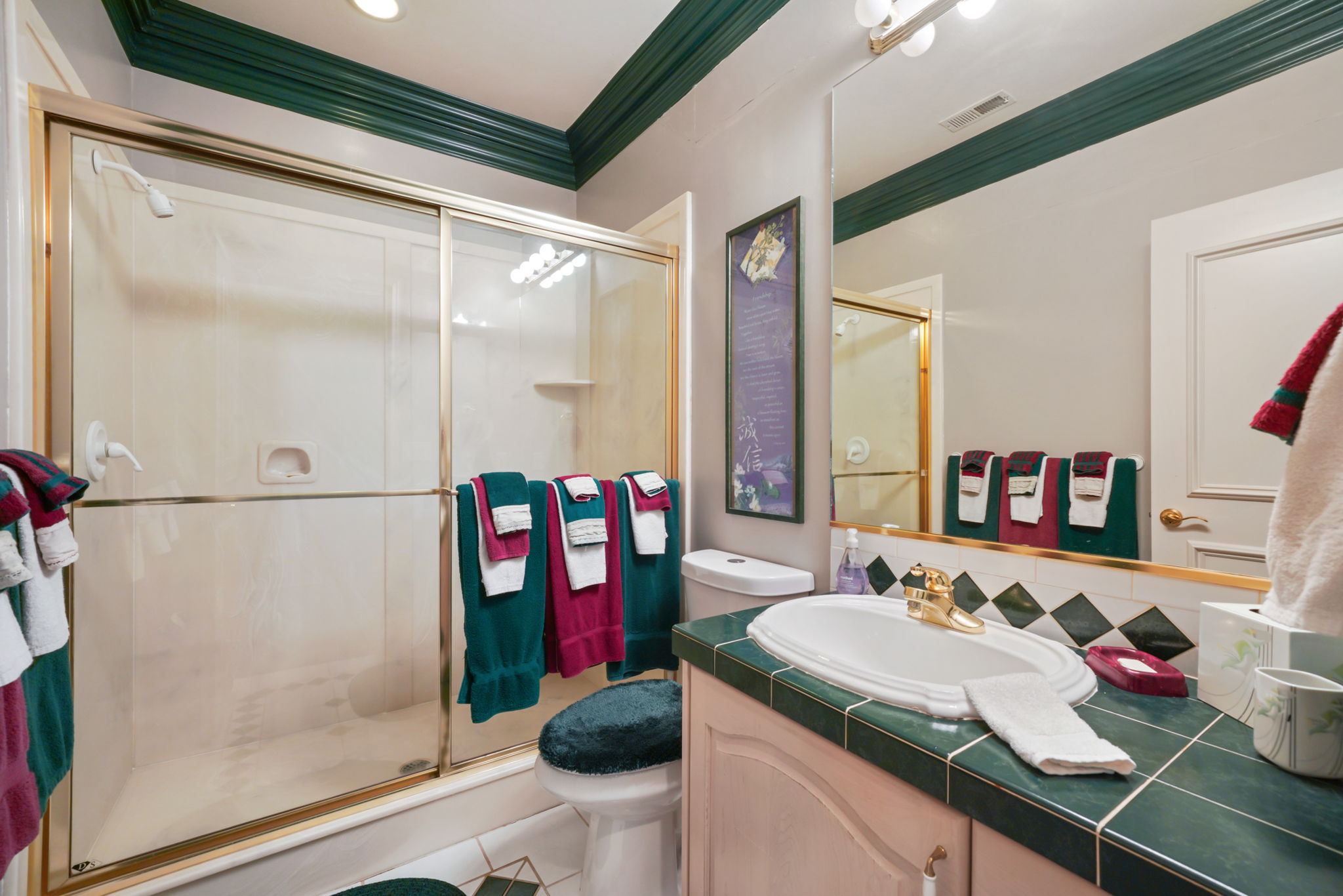 Bathroom with a shower stall, vanity, ornamental molding, tile patterned flooring, and tasteful backsplash