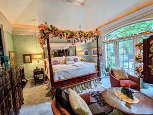 Carpeted bedroom featuring access to exterior, wallpapered walls, lofted ceiling, crown molding, and baseboards