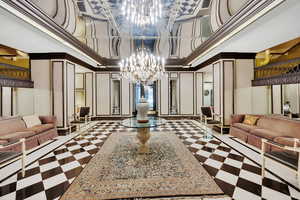 Common area featuring a decorative wall, a high ceiling, and crown molding