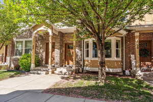 View of front of home featuring brick siding and a porch