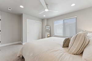 Primary bedroom with carpet flooring, baseboards, a closet, recessed lighting, and a ceiling fan