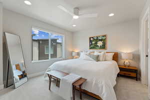 Primary bedroom featuring light carpet, recessed lighting, baseboards, and ceiling fan