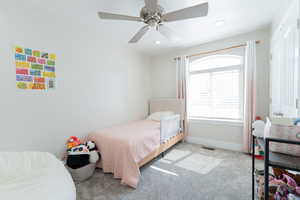 Bedroom with light carpet, ceiling fan, baseboards, and recessed lighting