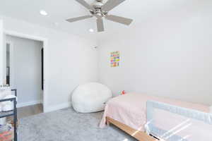 Carpeted bedroom with recessed lighting, a ceiling fan, and baseboards