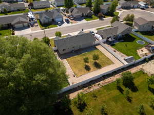 Aerial view of property and surrounding area with nearby suburban area