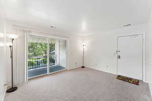 Empty room with carpet flooring and baseboards