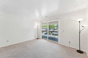 Empty room featuring carpet floors and baseboards
