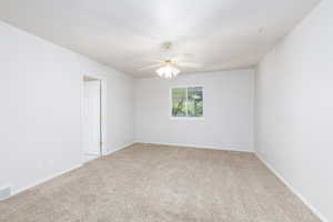 Bedroom featuring carpet floors, a ceiling fan, and baseboards