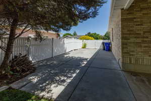 Fenced backyard featuring oversized patio and RV/boat storage area