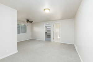 Bedroom featuring ceiling fan, light carpet, and baseboards