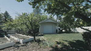 View of yard featuring vegetable gardens and shed
